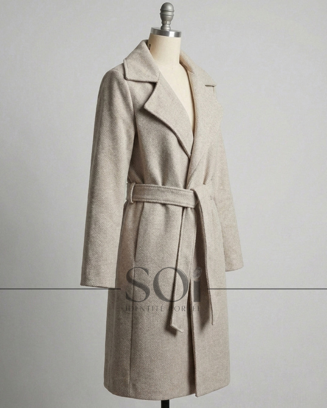 A mid-length tailored coat with a self-tie belt