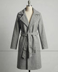 A mid-length tailored coat with a self-tie belt
